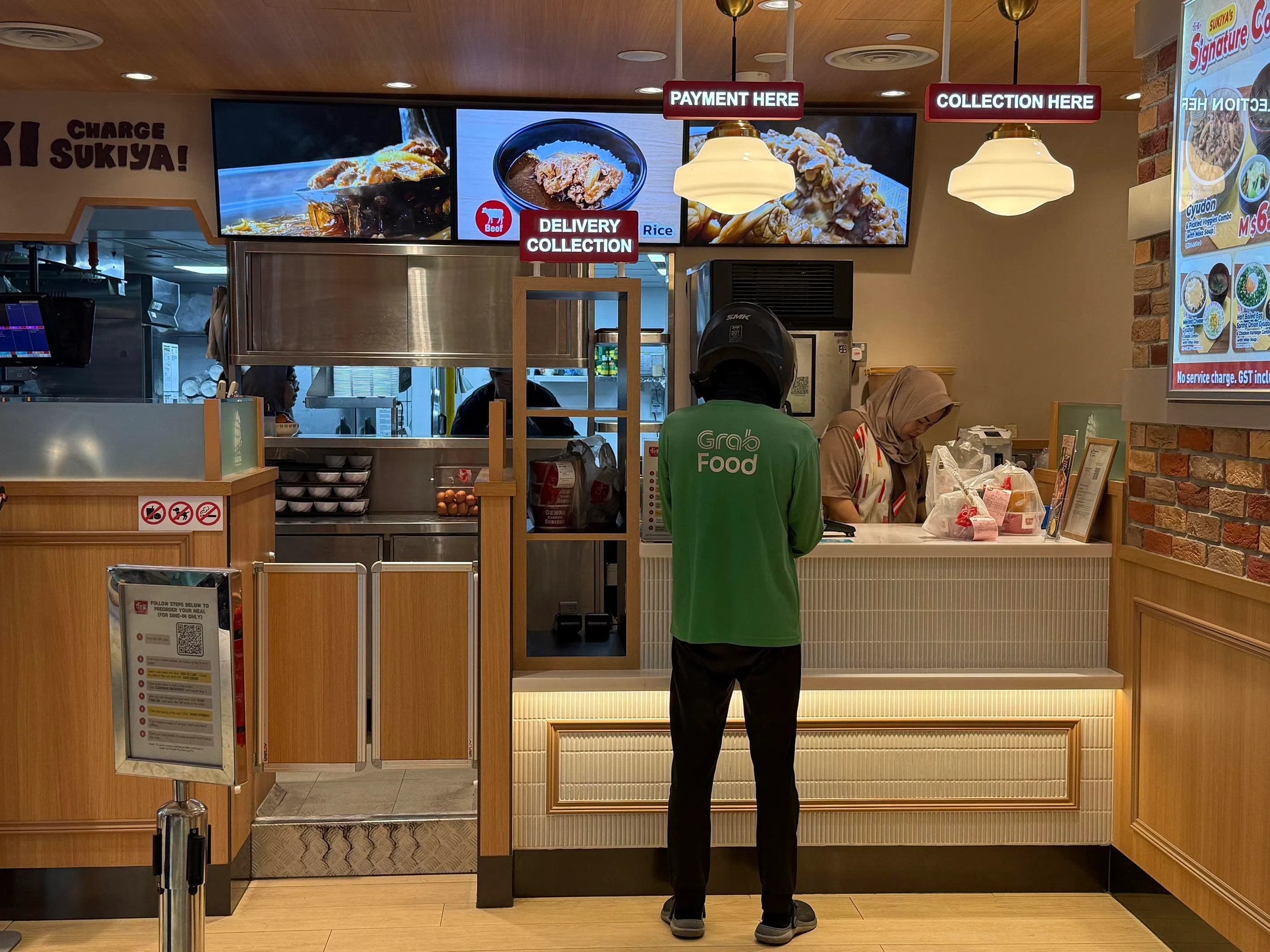 A food delivery rider collecting an order at Clementi Mall on Oct 14.