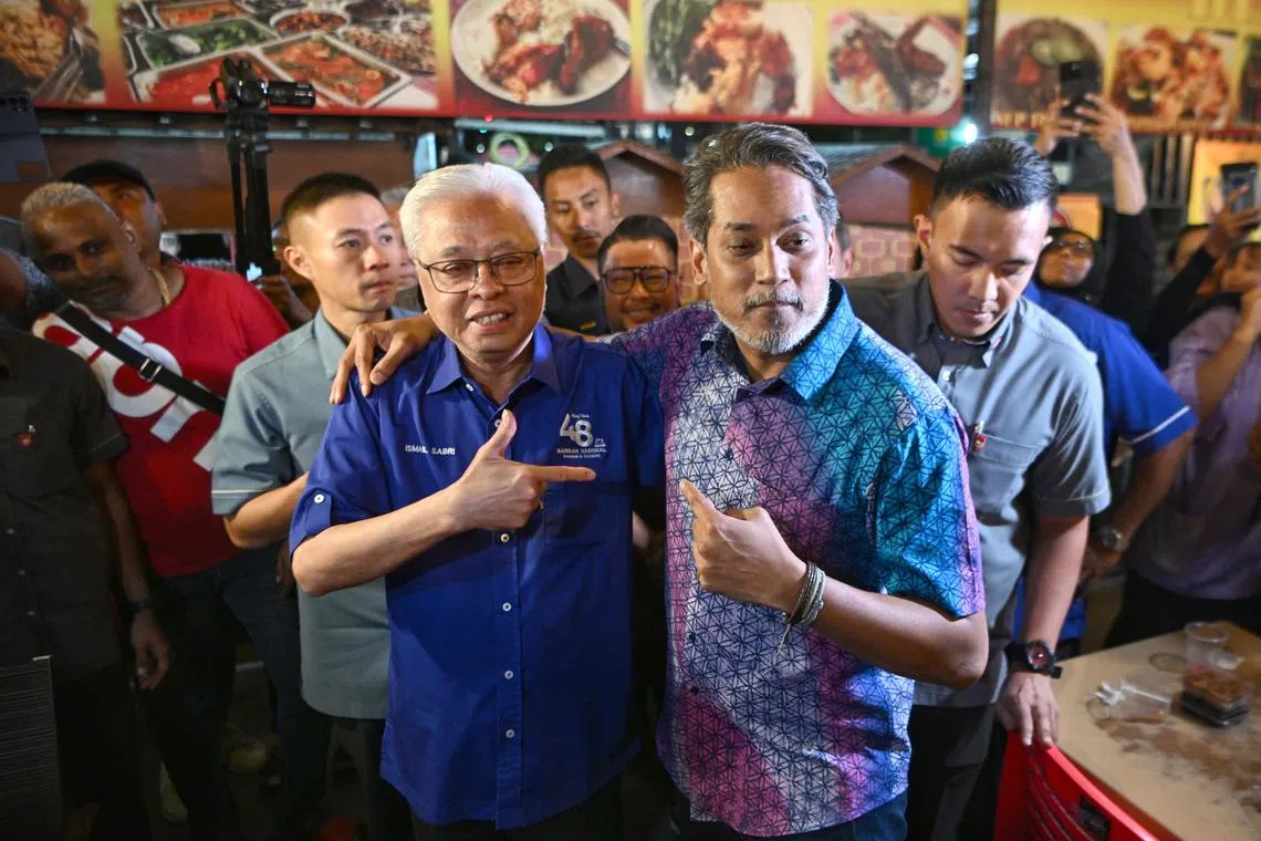 Caretaker Health Minister Khairy Jamaluddin (right), with caretaker Prime Minister Ismail Sabri Yaakob at an election campaign stop in Selangor.