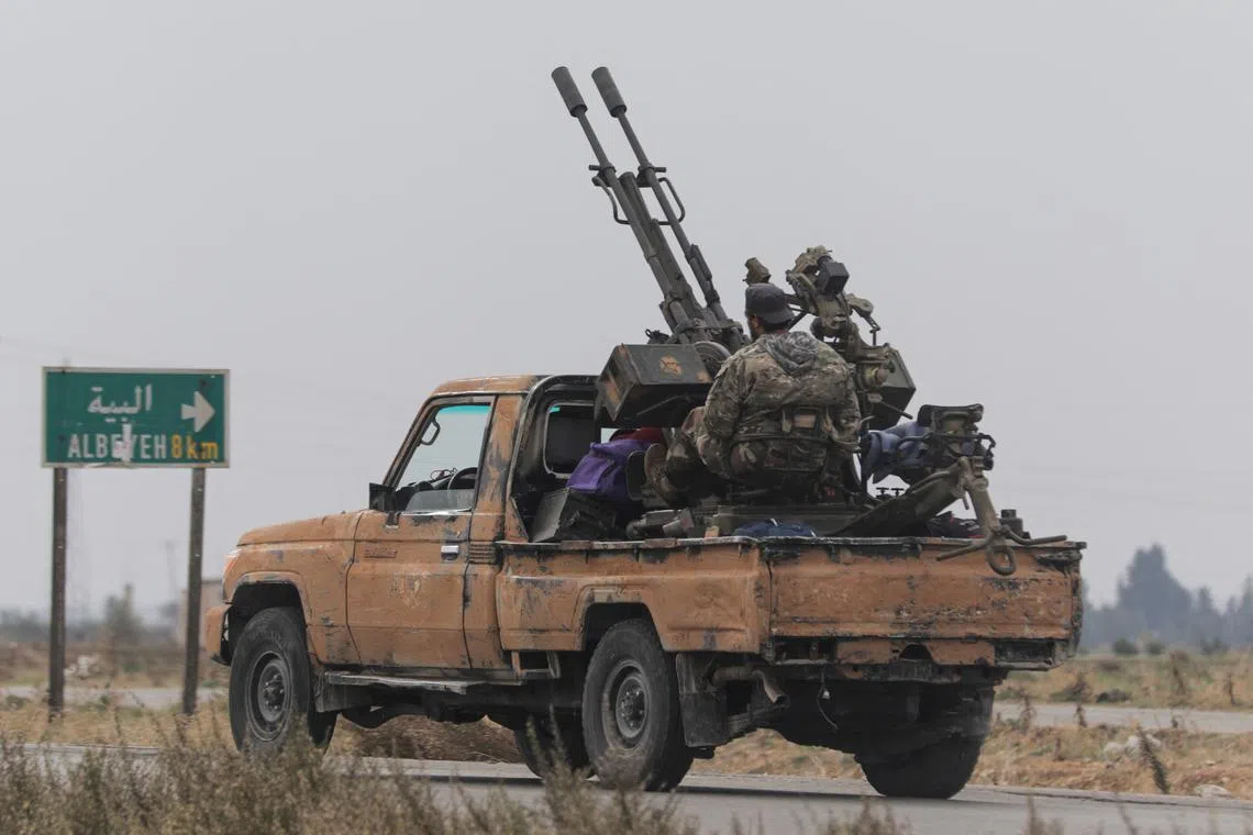 A rebel fighter sits on the back of a vehicle in Homs countryside, after Syrian rebels pressed their lightning advance on Saturday, saying they had seized most of the south, as government forces dug in to defend the key central city of Homs to try to save President Bashar al-Assad's 24-year rule, in Syria December 7, 2024. REUTERS/Mahmoud Hasano