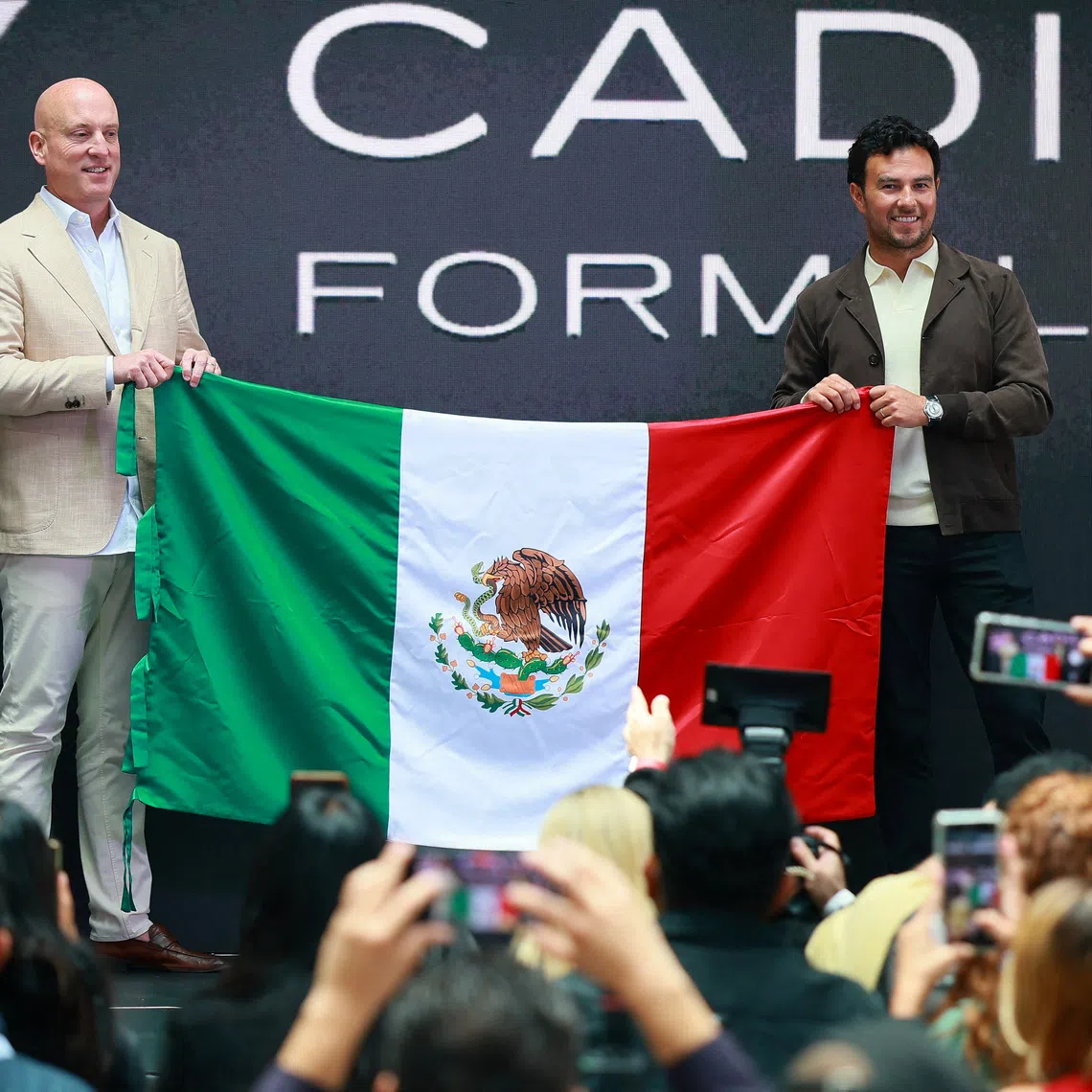FILE PHOTO: Formula One F1 - Mexican F1 driver Sergio Perez to speak to media after announcing his Cadillac team signing - Plaza Carso, Mexico City - August 27, 2025 Formula One driver Sergio Perez poses with Cadillac F1 team CEO, Dan Towriss and the flag of Mexico during his announcement of signing with the new Cadillac Formula One team for the 2026 season REUTERS/Eloisa Sanchez/File Photo