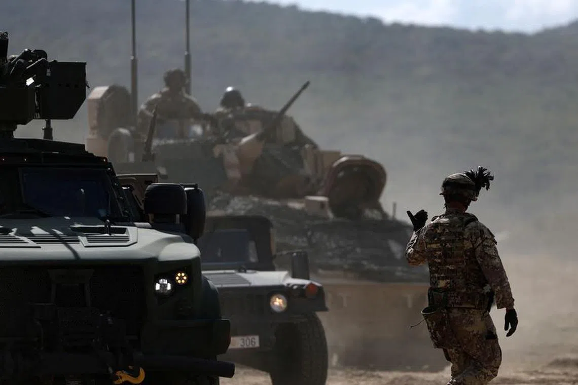 FILE PHOTO: Armoured vehicles move during \"Noble Blueprint 2023\" military exercise at Novo Selo military grounds, Bulgaria, September 26, 2023. The drill is organised by the NATO multinational brigade under Italy's command, including army personnel and equipment from Bulgaria, Greece, Montenegro, North Macedonia, Turkey, Albania and the U.S. REUTERS/Stoyan Nenov/File Photo