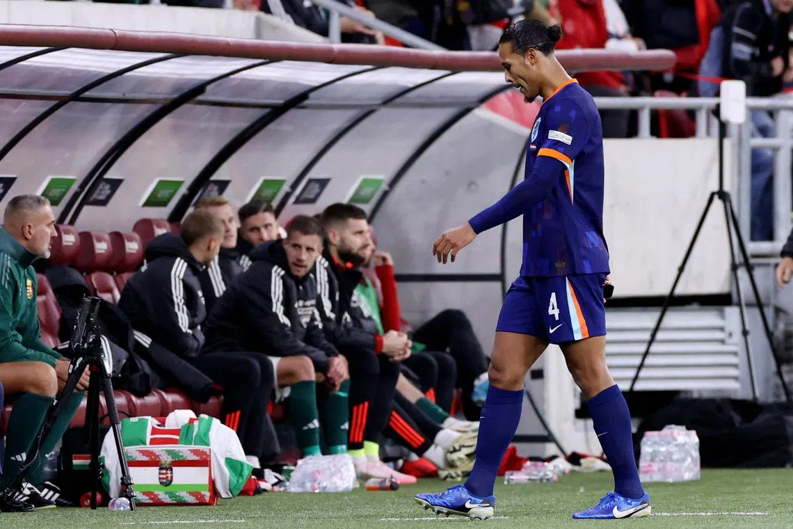 Netherlands' Virgil van Dijk walks out the pitch after being sent off against Hungary.
