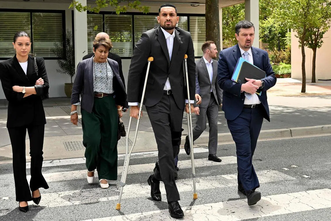 Australian tennis player Nick Kyrgios (centre) arriving on crutches to the magistrate's court in Canberra in February, when his assault case was heard and dismissed on mental health grounds. 
