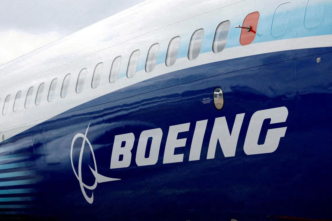 FILE PHOTO: FILE PHOTO: The Boeing logo is seen on the side of a Boeing 737 MAX at the Farnborough International Airshow, in Farnborough, Britain, July 20, 2022.  REUTERS/Peter Cziborra/File Photo/File Photo