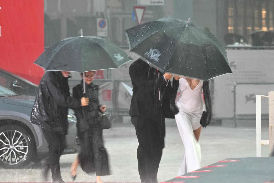 Rain sent staff and crew of the Georgian film April running for cover, and left the Venice film festival's red carpet covered in puddles.