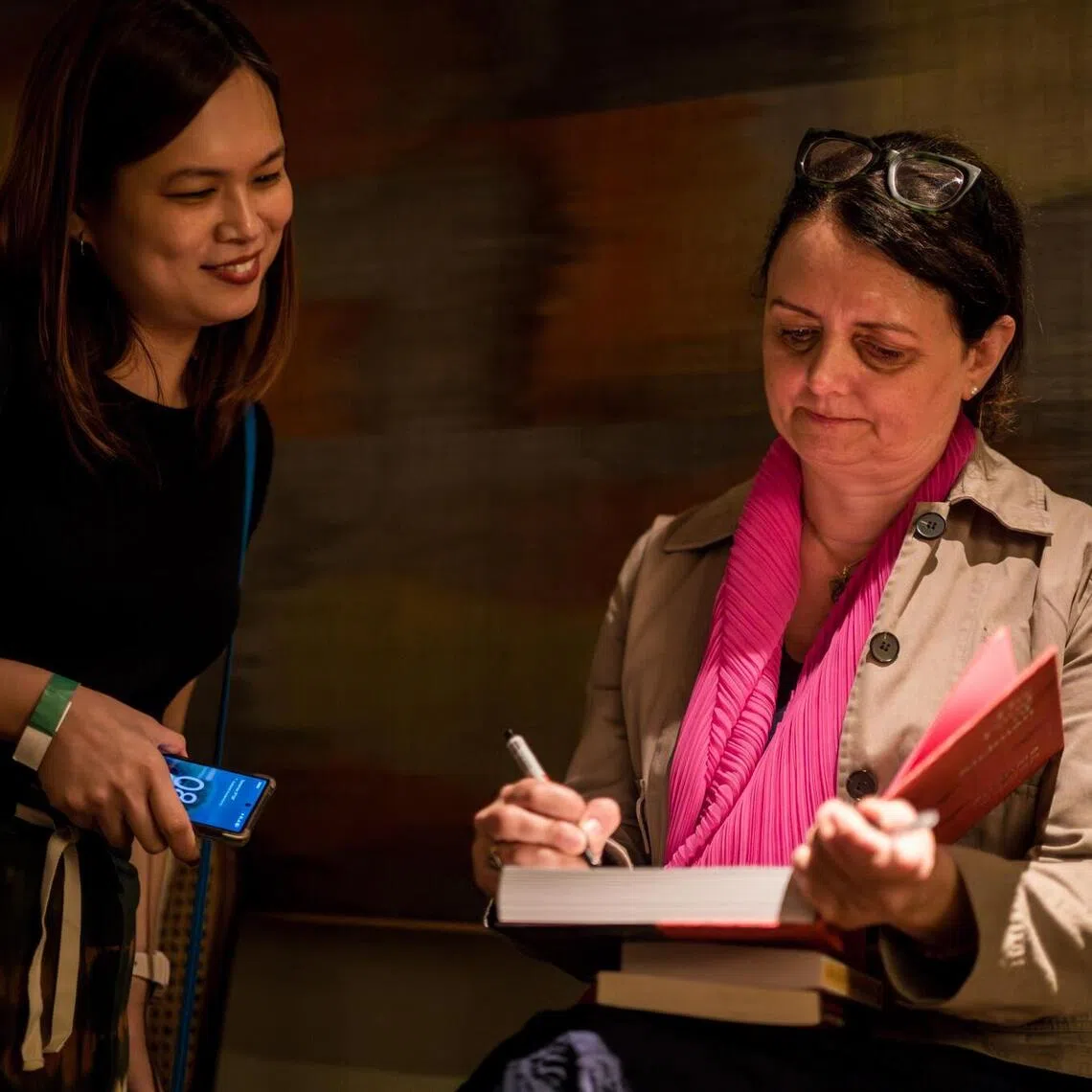 Author Fuchsia Dunlop (right) signing a book for a fan at her Salon session at Belimbing restaurant.