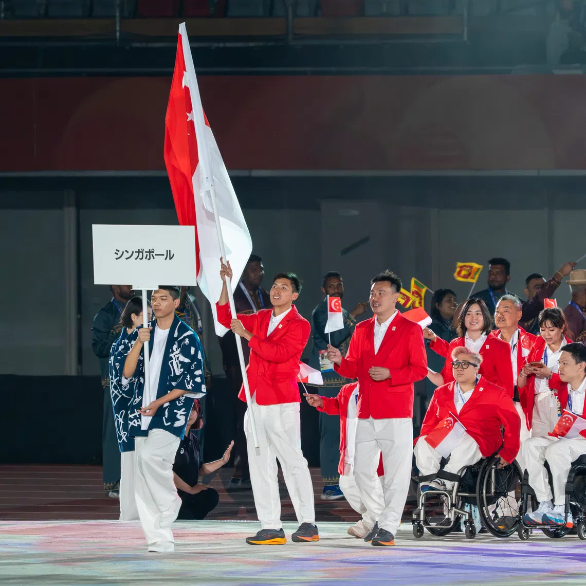 Team Singapore, with para-sprinter James Ang as flag bearer, at the 2026 Asian Para Games opening ceremony.