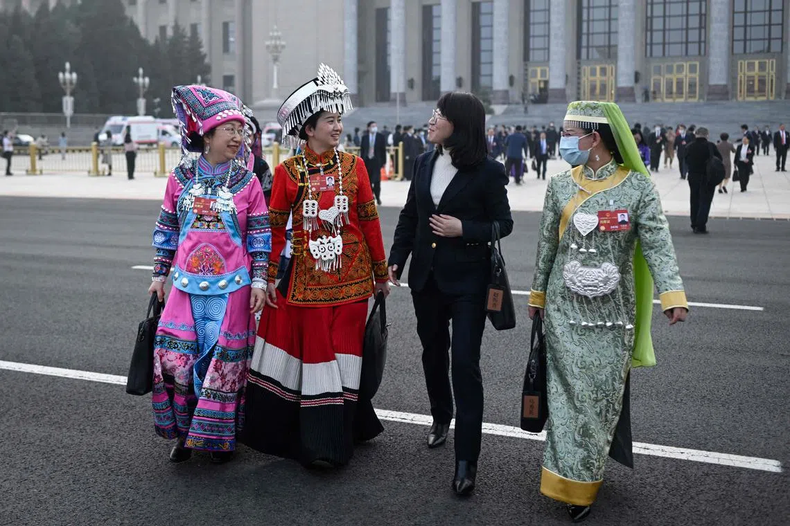Ethnic minority delegates leave after the second plenary session of the National People's Congress (NPC) at the Great Hall of the People in Beijing on March 7, 2023. 