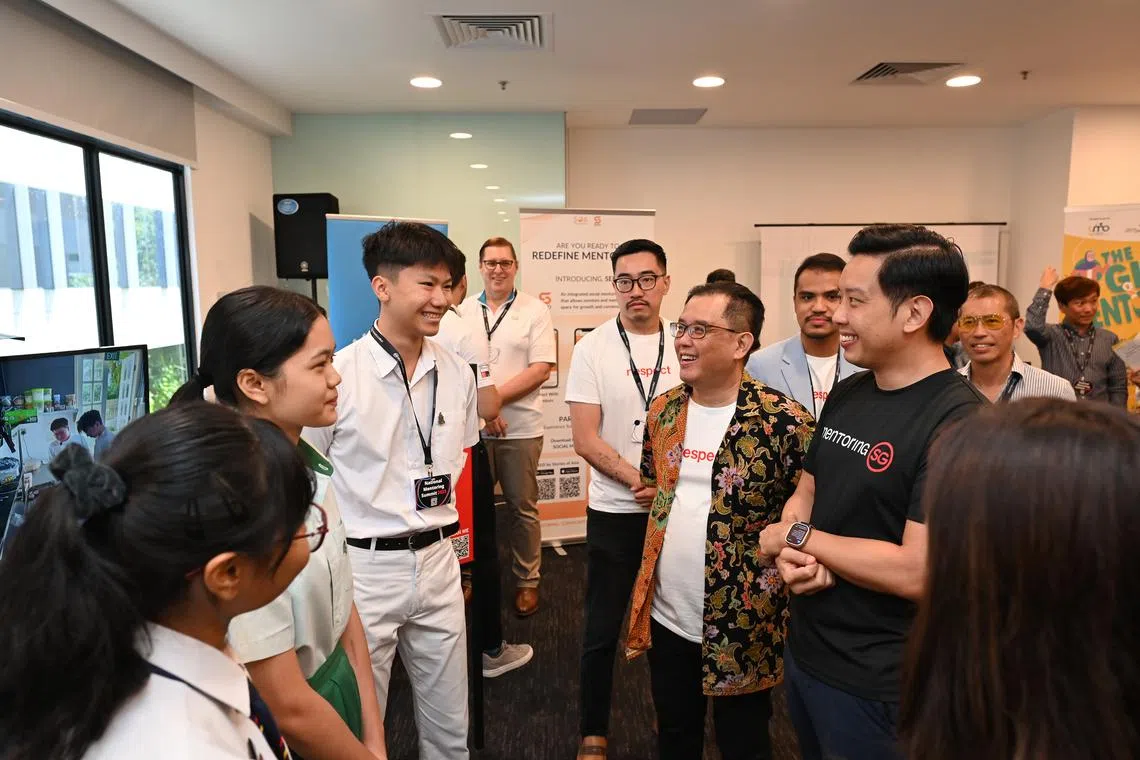 Minister of State for Culture, Community and Youth Alvin Tan (right) with student mentees.