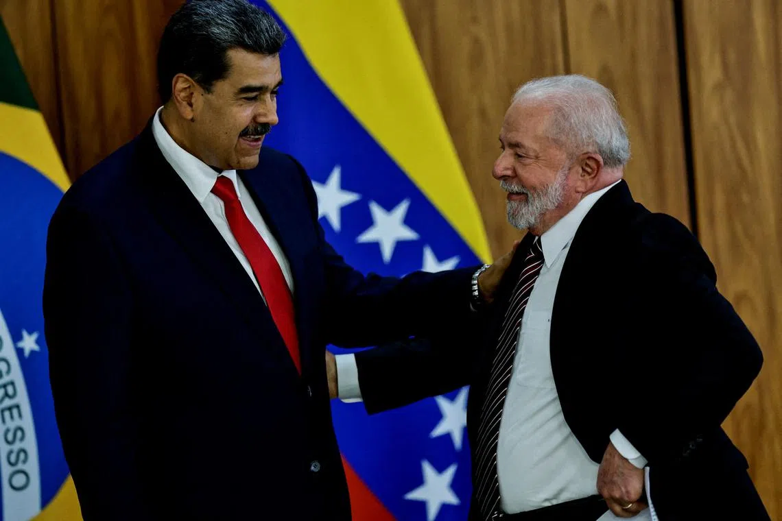 FILE PHOTO: Venezuela's President Nicolas Maduro and Brazil's President Luiz Inacio Lula da Silva gesture before a summit with presidents of South America to discuss the re-launching of the regional cooperation bloc UNASUR, in Brasilia, Brazil, May 29, 2023. REUTERS/Ueslei Marcelino/File Photo