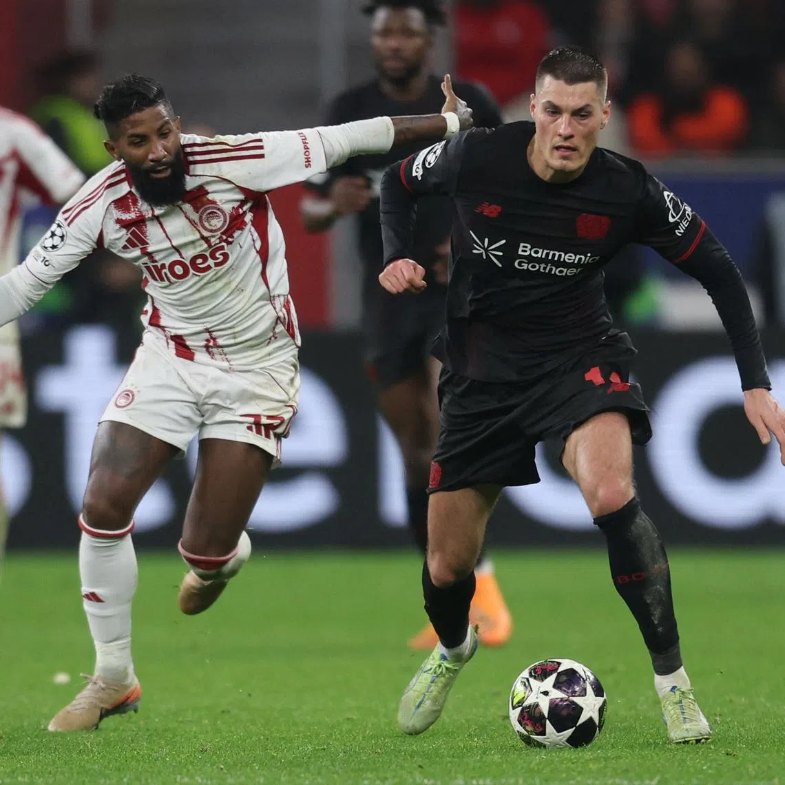 Soccer Football - UEFA Champions League - Play Off - Second Leg - Bayer Leverkusen v Olympiacos - BayArena, Leverkusen, Germany - February 24, 2026 Bayer Leverkusen's Patrik Schick in action with Olympiacos' Rodinei REUTERS/Leon Kuegeler