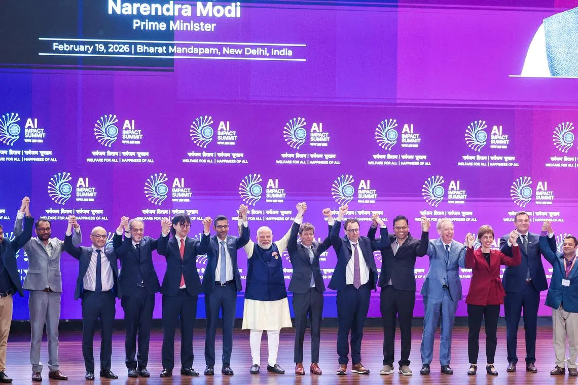 Indian PM Narendra Modi (seventh from left) and global tech leaders at the AI Impact Summit in New Delhi on Feb 19.