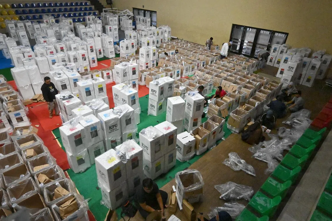 Election officials preparing ballot boxes at an elections logistics hub in Jakarta on Feb 6.
