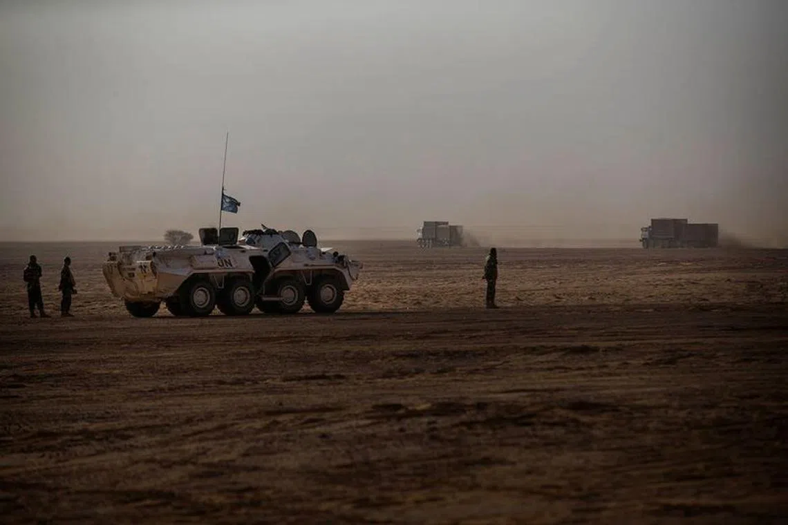 An armored vehicle escorting a MINUSMA logistic convoy from Gao to Kidal, is parked as trucks pass by, Mali February 16, 2017. Each month MINUSMA organizes logistic convoys involving hundreds of civilians and military vehicles to supply remote UN bases in northern Mali. Picture taken February 16, 2017. MINUSMA/Sylvain Liechti handout via REUTERS/File Photo