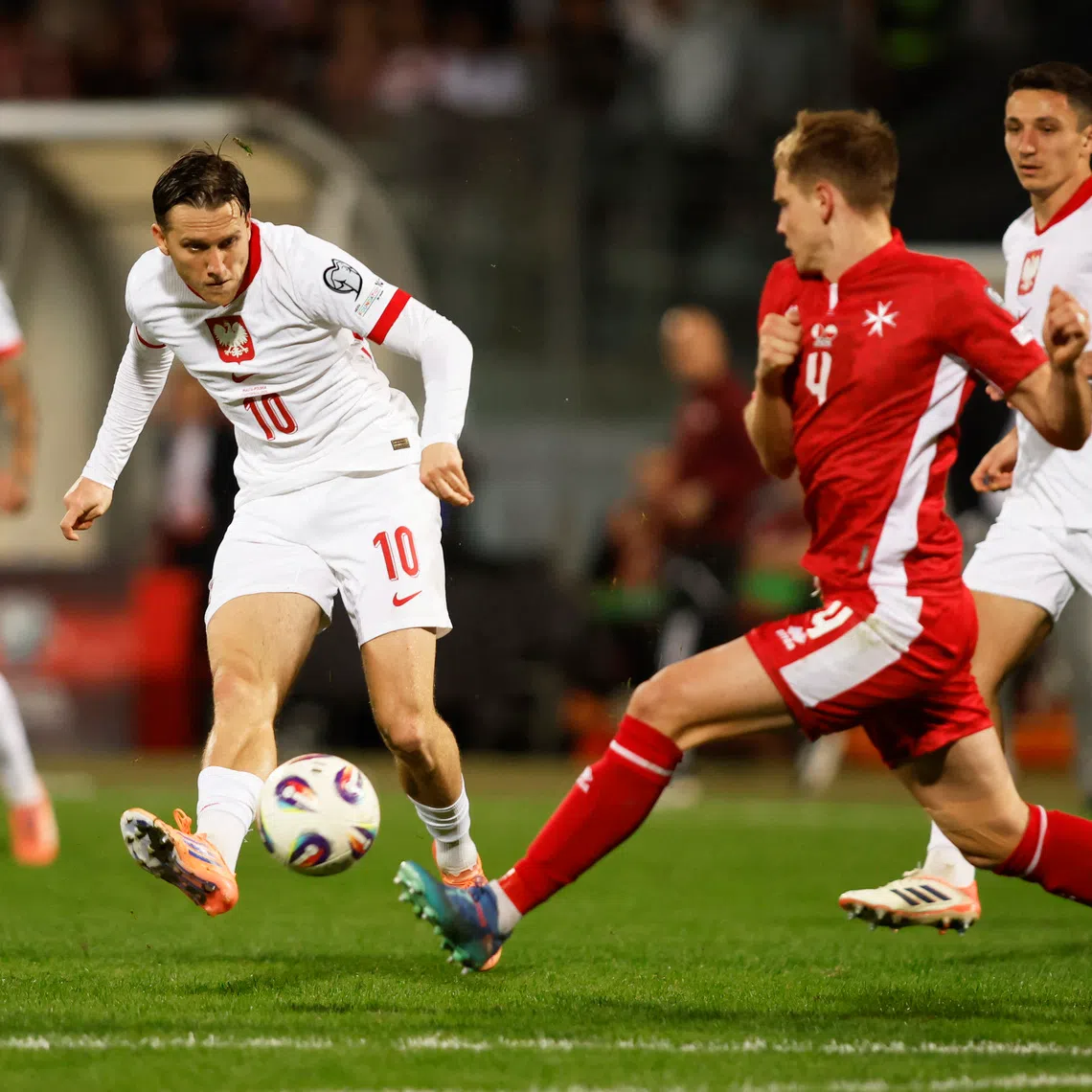 Soccer Football - World Cup - UEFA Qualifiers - Group G - Malta v Poland - National Stadium Ta' Qali, Attard, Malta - November 17, 2025 Poland's Piotr Zielinski in action with Malta's Gabriel Mentz REUTERS/Darrin Zammit Lupi