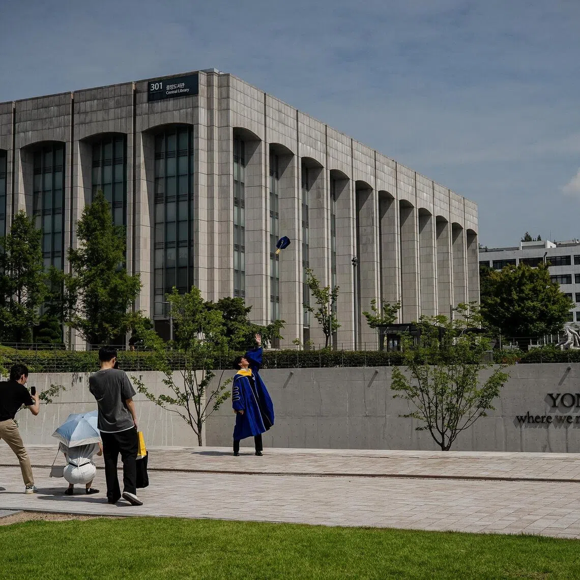 A graduate tosses his cap at Yonsei University in Seoul, on Saturday, Aug. 1, 2025. South KoreaÕs elite universities have been left scrambling after it emerged that testing season was marred by a spate of mass cheating incidents involving AI. (Tina Hsu/The New York Times)