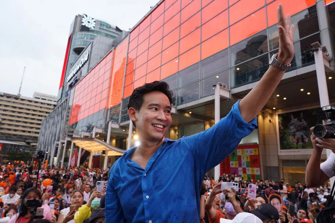 (FILES) Move Forward Party leader and prime ministerial candidate Pita Limjaroenrat waves to his supporters during a rally in front of Central World in Bangkok on July 9, 2023. The findings of an investigation into Thai PM frontrunner Pita Limjaroenrat will be submitted to the country's Constitutional Court, officials said July 12. (Photo by Sarah Lai / AFP)