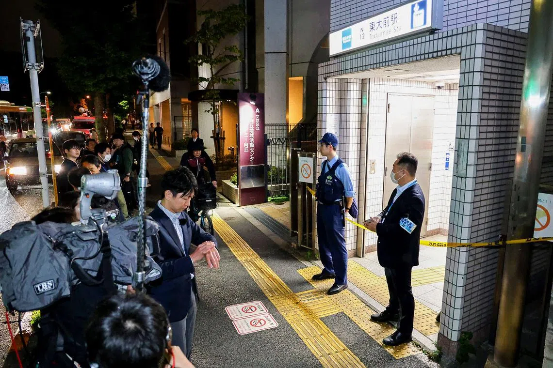 Police officers stand guard at an entrance of Todai-mae station after a stabbing incident in Tokyo on May 7, 2025. 