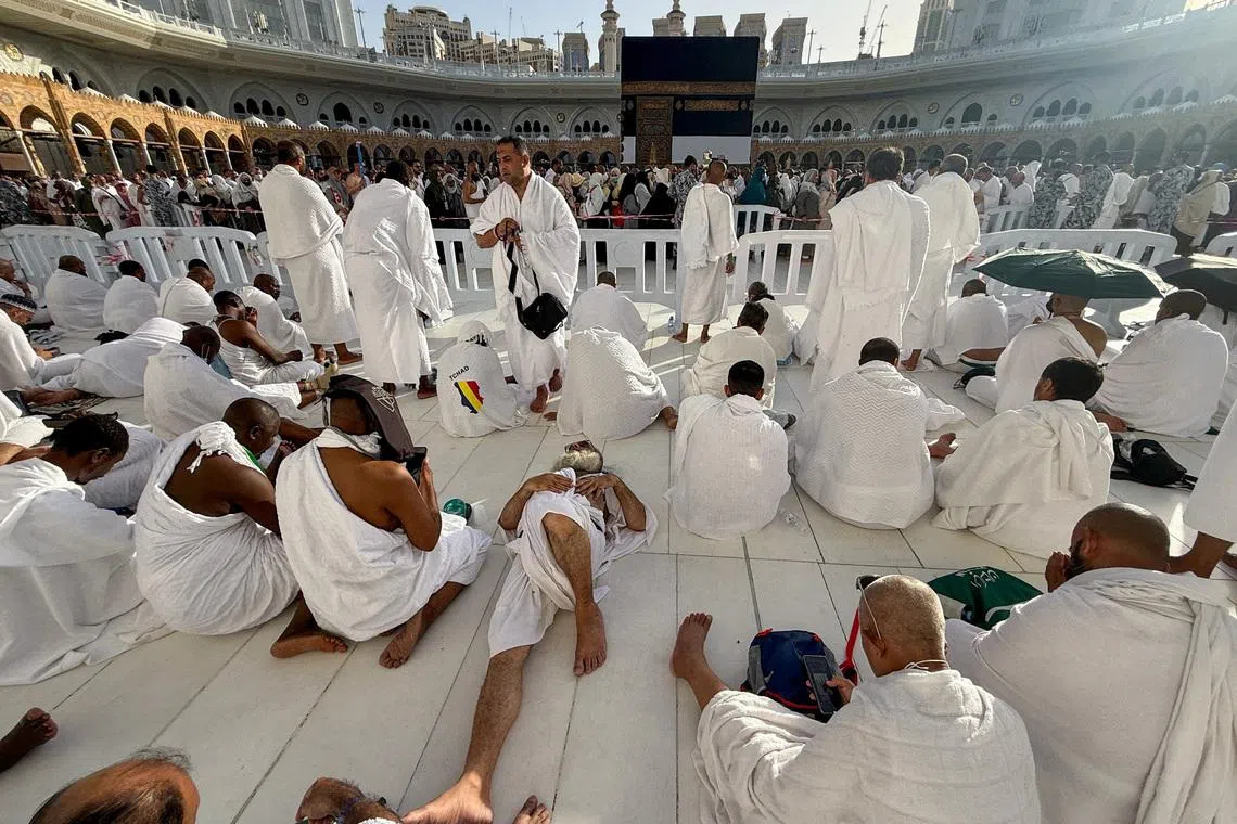 Muslim pilgrims resting near the Kaaba at the Grand Mosque, ahead of the annual hajj pilgrimage, in Mecca, Saudi Arabia on May 18, 2026. 