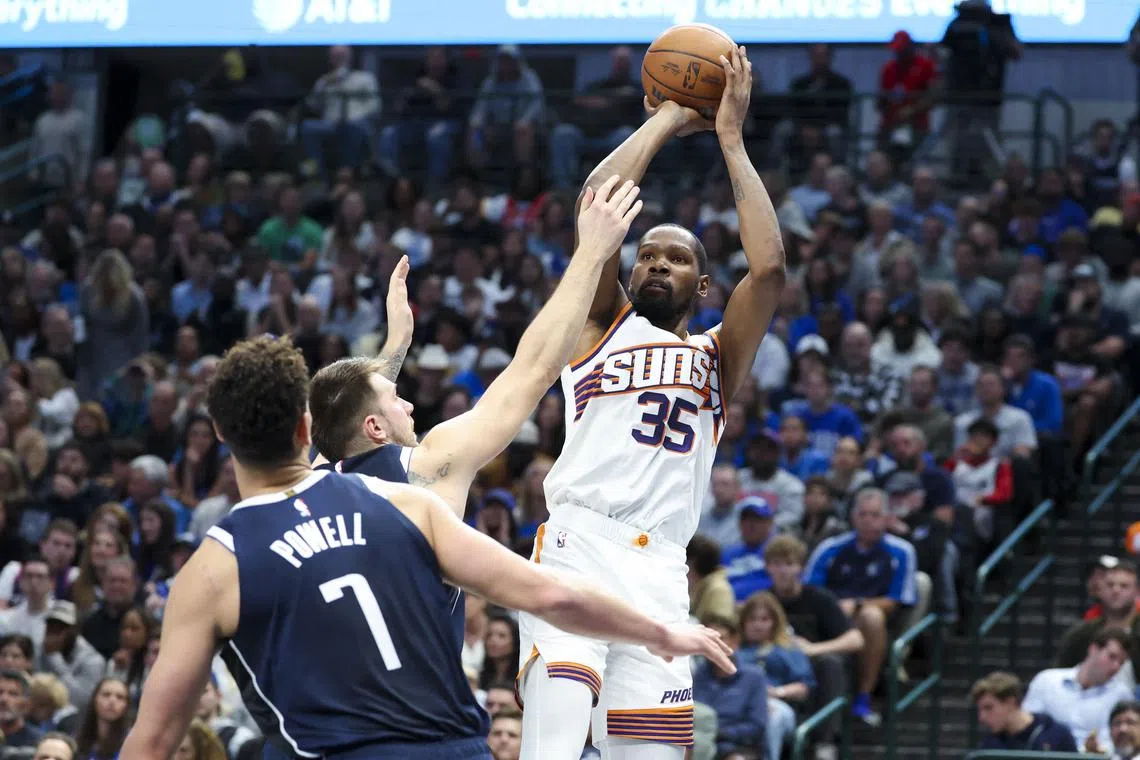 Nov 8, 2024; Dallas, Texas, USA;  Phoenix Suns forward Kevin Durant (35) shoots over Dallas Mavericks guard Luka Doncic (77) and Dallas Mavericks center Dwight Powell (7) during the third quarter at American Airlines Center. Mandatory Credit: Kevin Jairaj-Imagn Images/ File Photo