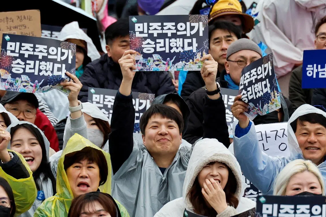 FILE PHOTO: People holding placards that read \"Democracy won\" attend a rally to celebrate the expulsion of South Korean President Yoon Suk Yeol in Seoul, South Korea, April 5, 2025. REUTERS/Kim Soo-hyeon/File Photo