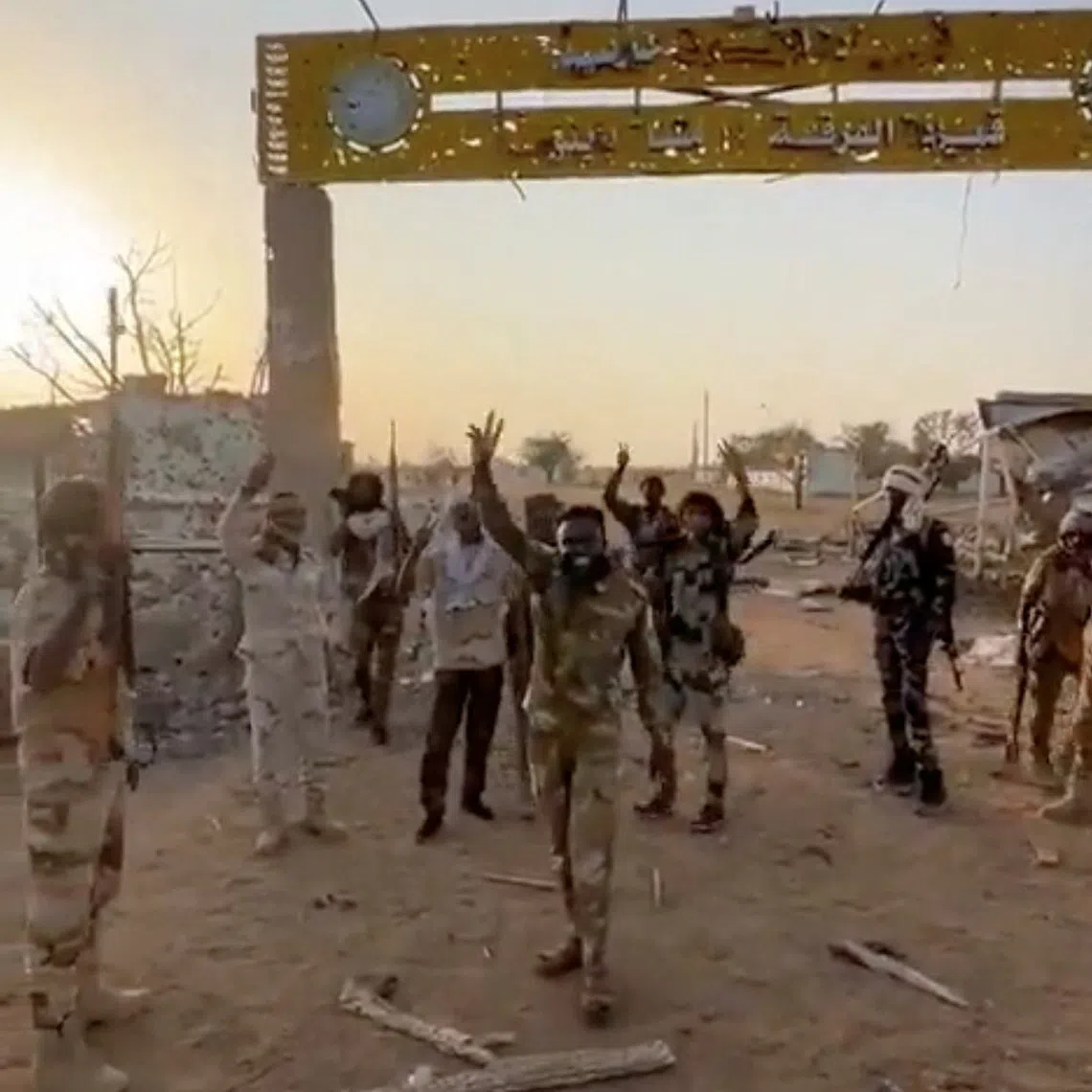 Members of Sudan's paramilitary Rapid Support Forces (RSF) stand in front of the main gate of the 22nd SAF Infantry Division, in Babanusa, Sudan, in this screengrab obtained from a social media video released December 1, 2025. Social Media/via REUTERS