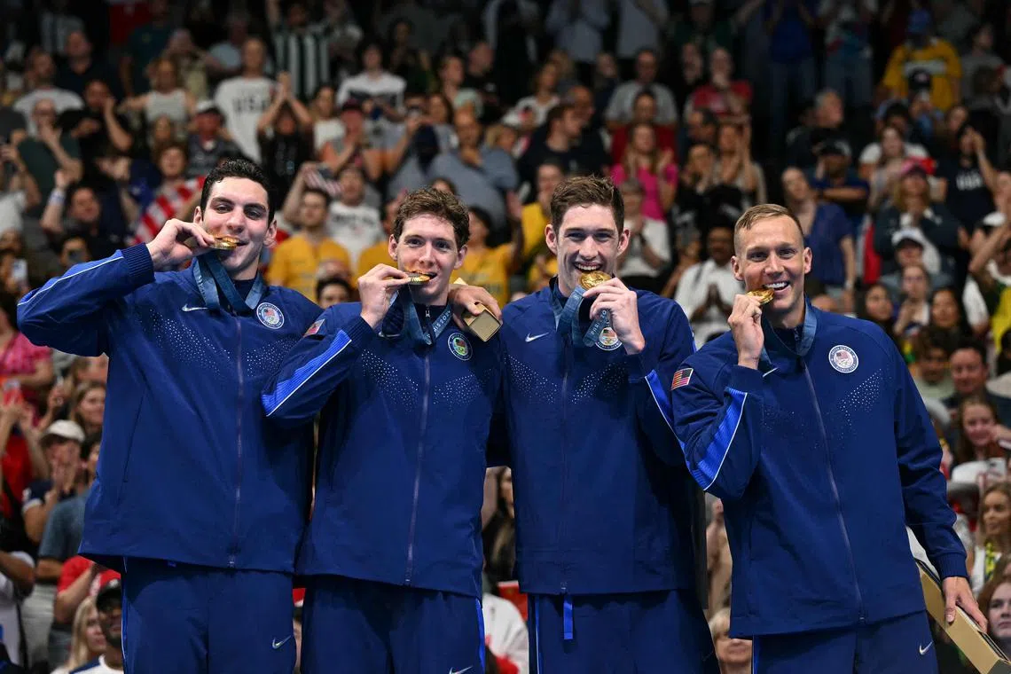 Gold medallists Jack Alexy, Chris Guiliano, Hunter Armstrong and Caeleb Dressel pose with their medals after winning the men's 4x100m freestyle relay.