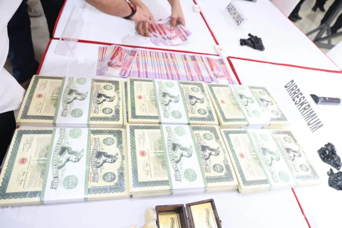 The counterfeit $10,000 notes confiscated by the Indonesia National Police, alongside old bearer bonds that were discovered. The Indonesian police did not say if the bonds were counterfeit as well.