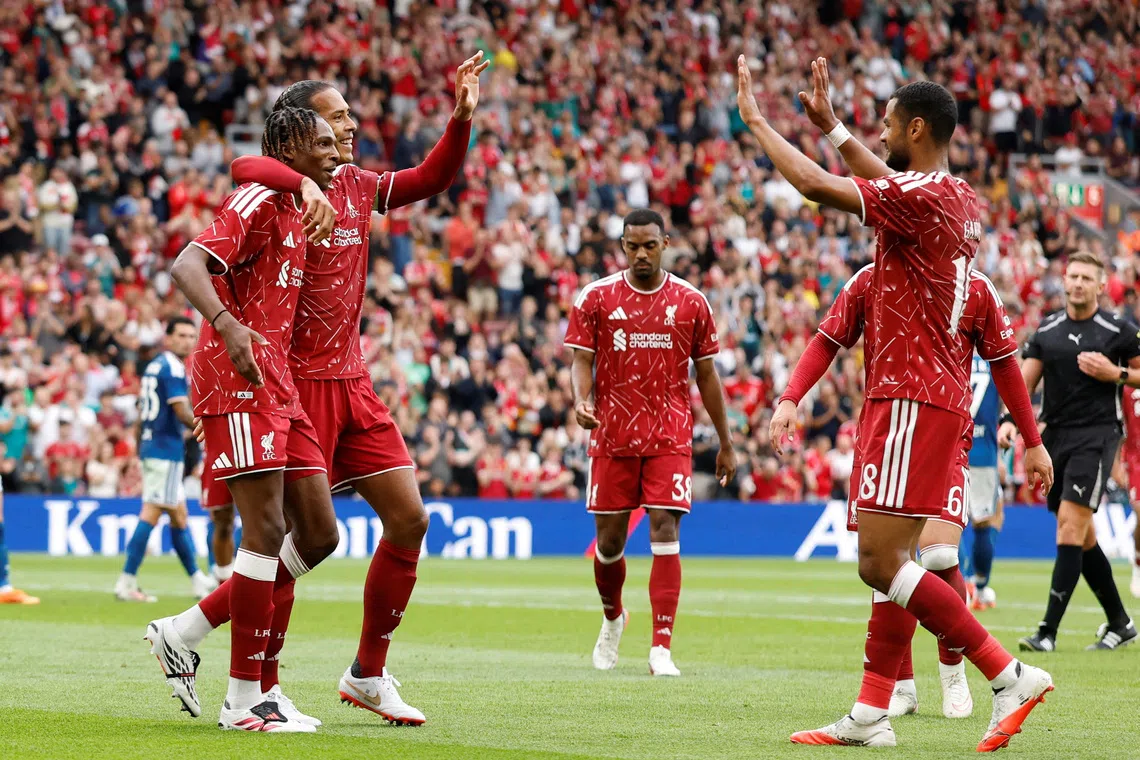 Liverpool’s Jeremy Jacquet celebrates scoring his first goal with teammates Virgil van Dijk and Cody Gakpo.