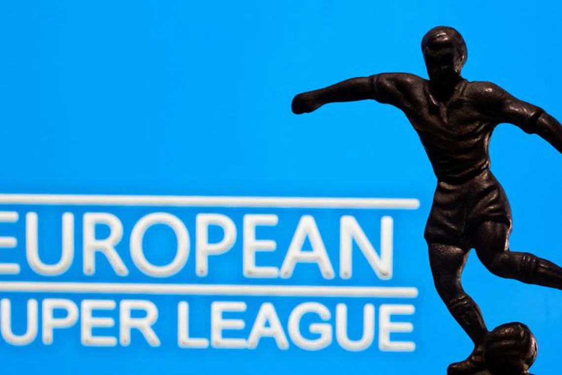 FILE PHOTO: A metal figure of a football player with a ball is seen in front of the words \"European Super League\" in this illustration taken April 20, 2021. REUTERS/Dado Ruvic/Illustration/File Photo