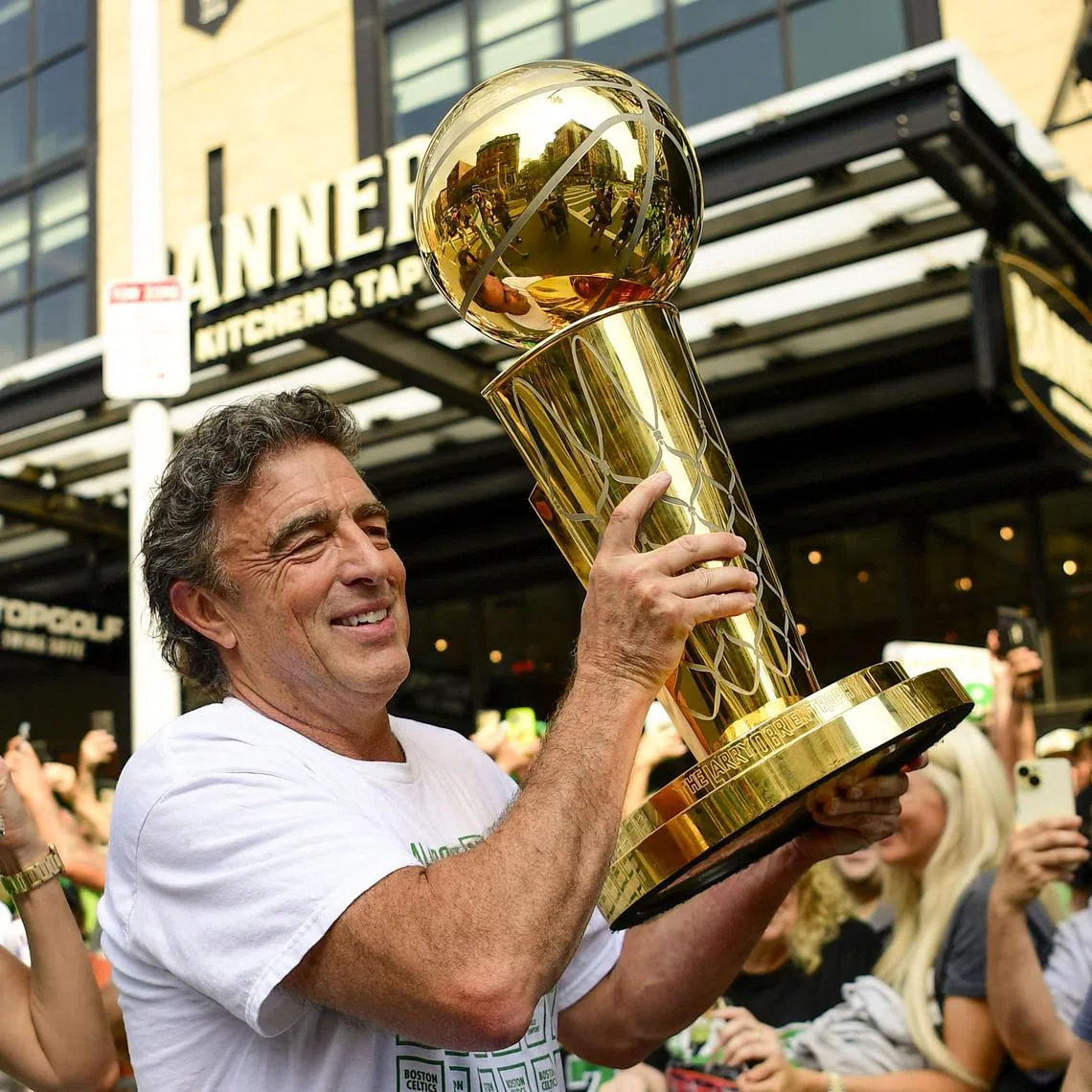 Owner Wyc Grousbeck of the Boston Celtics holding the Larry O'Brien Championship Trophy during the 2024 Boston Celtics championship parade.