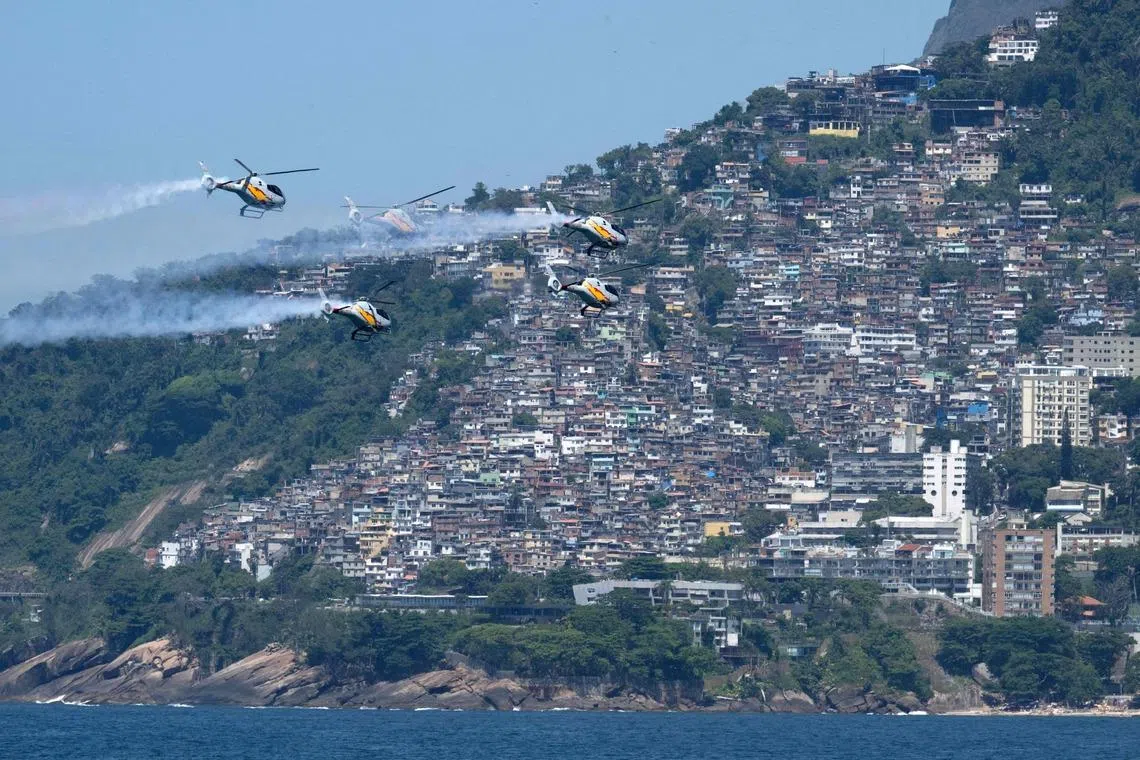 Helicopters from the Spanish Air and Space Force's ASPA patrol performing an aerial display over Ipanema Beach in Rio de Janeiro, Brazil on Jan 28, 2026. The event makes the centenary of the 1926 Plus Ultra flight, the first single-aircraft crossing of the South Atlantic from Spain to South America. 