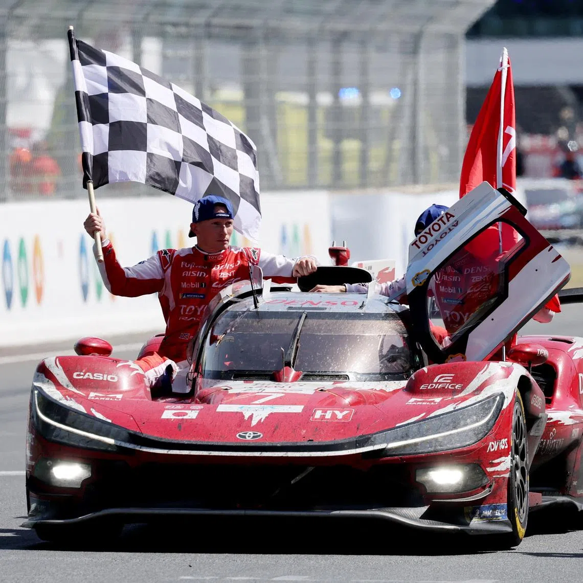 The 24 Hours of Le Mans - Circuit de la Sarthe, Le Mans, France - June 14, 2026 Toyota Racing's Mike Conway, Kamui Kobayashi, and Nyck de Vries celebrate after winning the 24 Hours of Le Mans REUTERS/Stephane Mahe