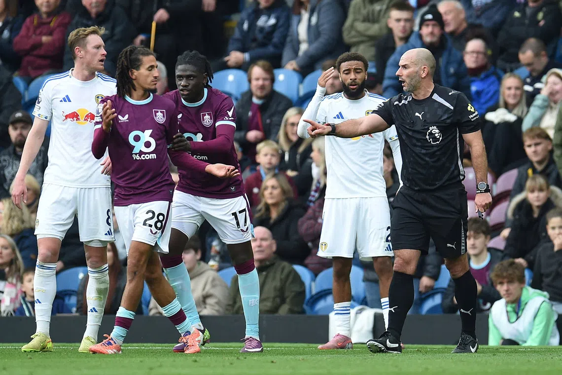 FILE PHOTO: Soccer Football - Premier League - Burnley v Leeds United - Turf Moor, Burnley, Britain - October 18, 2025 Burnley's Hannibal Mejbri remonstrates with referee Tim Robinson REUTERS/Peter Powell