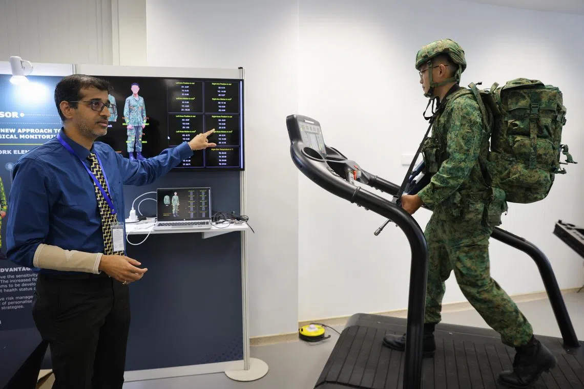 ahheat11 ST20230111_202347946121 Ong Wee Jin / Aqil Hamzah / 

Assoc Prof Ali Asgar S. Bhagat (left), Departments of Biomedical Engineering, NUS, demonstrates of an ongoing research into integrating wearable sensors that measure motion and temperature into the a soldier's uniform.

The Heat Resilience and Performance Centre (HRPC) was launched at the Yong Loo Lin School of Medicine, Wednesday, Jan 11, 2023. The facility is a tripartite collaboration between the Singapore Armed Forces (SAF), DSO National Laboratories and the National University of Singapore (NUS), set up to address the long-term challenges of rising temperatures.