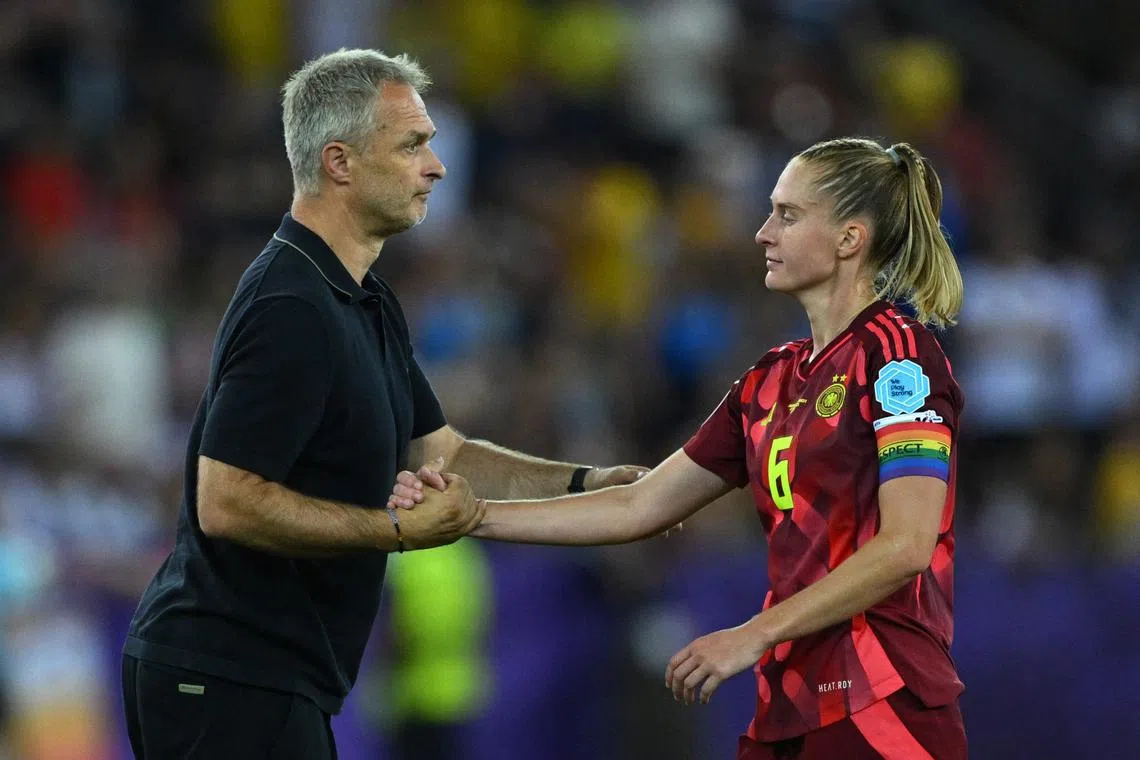 Soccer Football - UEFA Women's Euro 2025 - Group C - Sweden v Germany - Stadion Letzigrund, Zurich, Switzerland - July 12, 2025  Germany coach Christian Wuck shakes hands with Janina Minge after the match REUTERS/Annegret Hilse