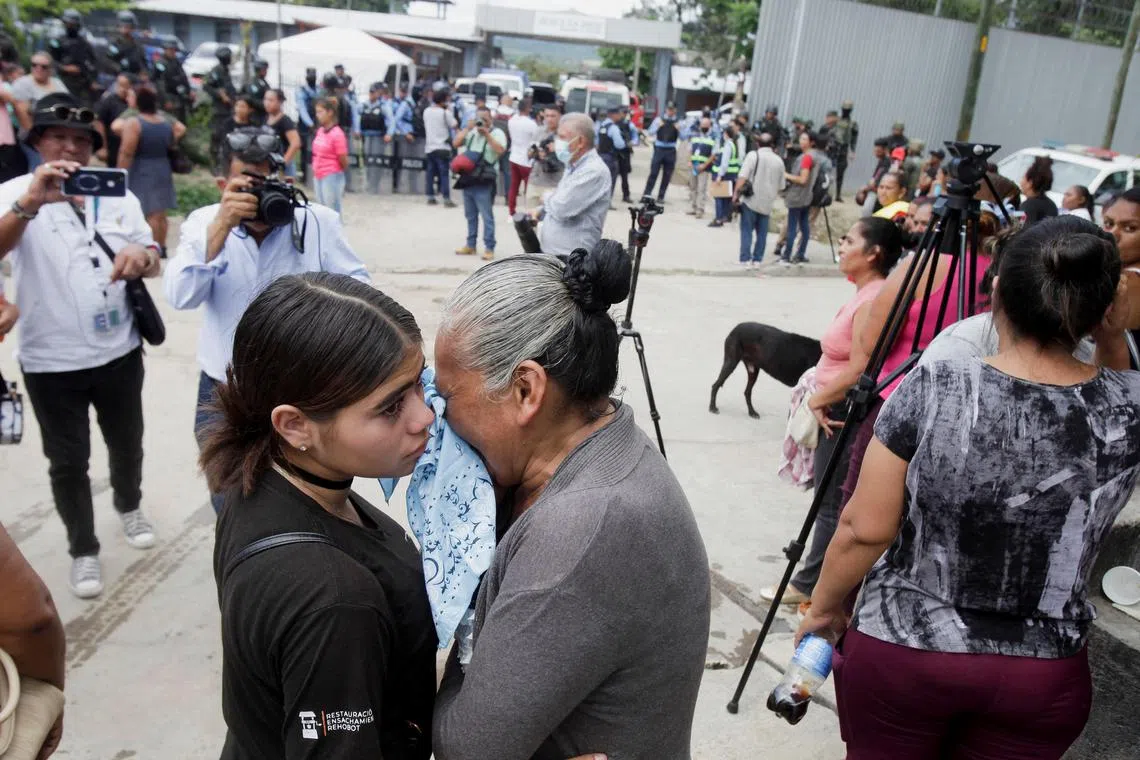 Relatives of inmates wait for news about their loved ones outside the prison.