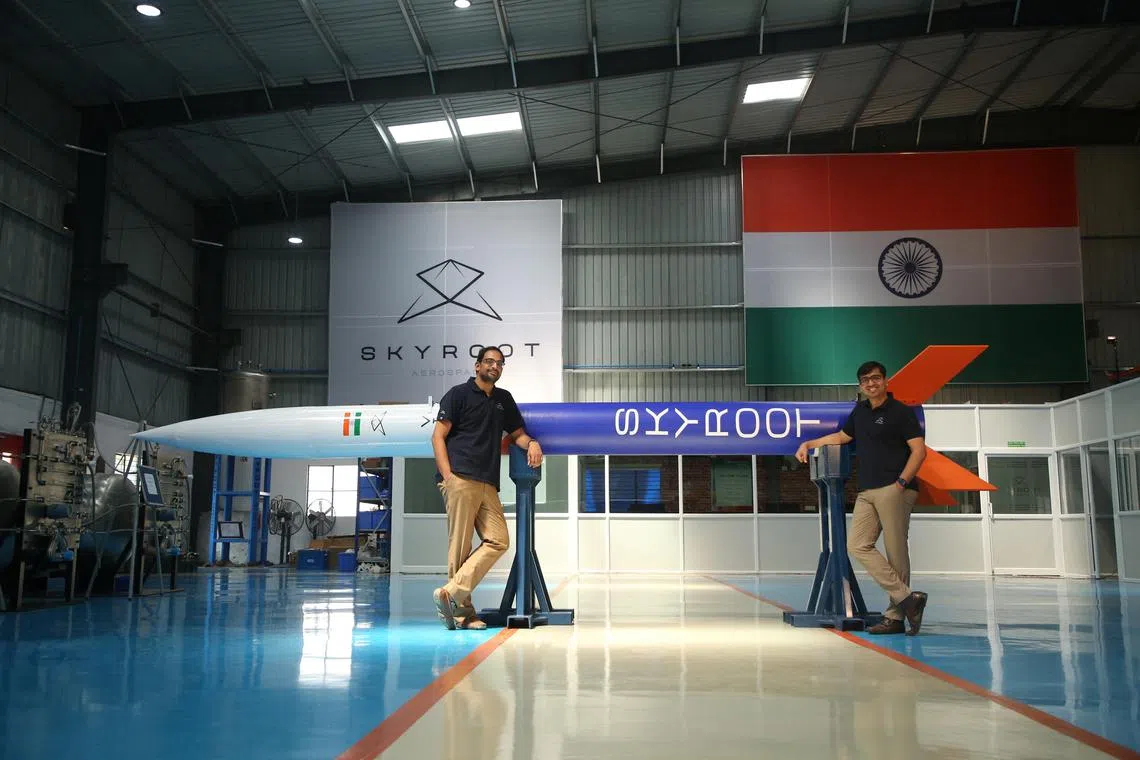 Mr Pawan Chandana and Mr Bharath Daka, founders of aerospace start-up Skyroot, pose for a photograph with a mockup of their India’s first privately funded rocket.