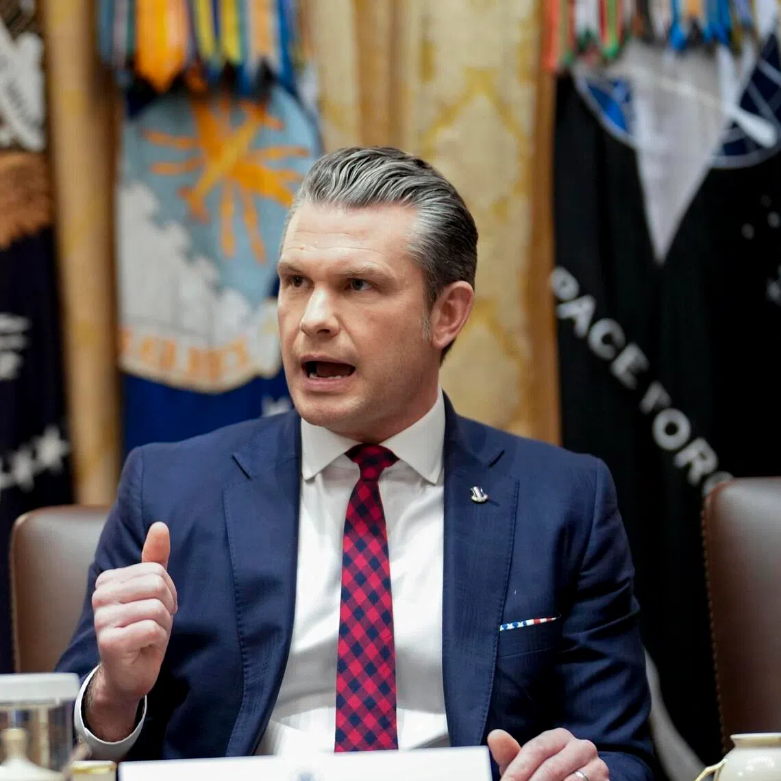 Secretary of Defense Pete Hegseth speaks alongside President Donald Trump during a cabinet meeting in the Cabinet Room of the White House in Washington, on Tuesday, Dec. 2, 2025. Hegseth said on Tuesday that he had not noticed survivors in the water during U.S. military strikes that killed 11 people in the Caribbean in September. (Doug Mills/The New York Times) 