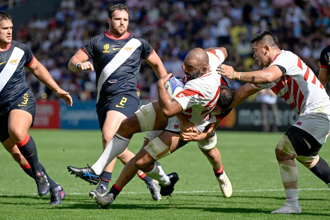 Japan captain Michael Leitch is tackled by an Argentina player during their Rugby World Cup Pool D match on Sunday. Japan lost 39-27 and did not advance to the quarter-finals.