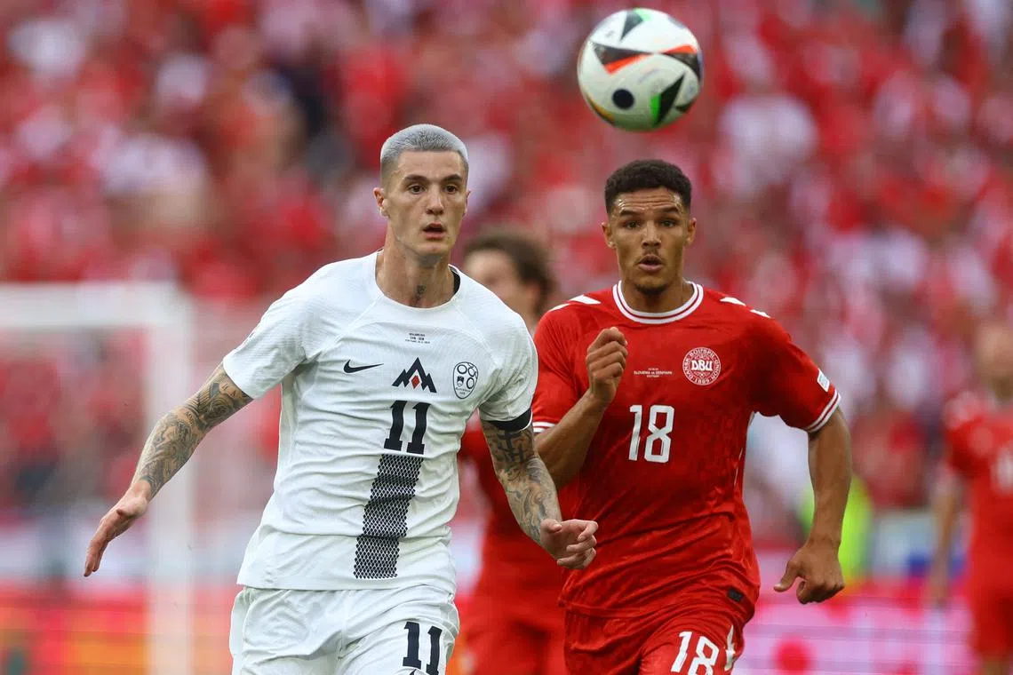FILE PHOTO: Soccer Football - Euro 2024 - Group C - Slovenia v Denmark - Stuttgart Arena, Stuttgart, Germany - June 16, 2024 Slovenia's Benjamin Sesko in action with Denmark's Alexander Bah REUTERS/Lee Smith/File Photo