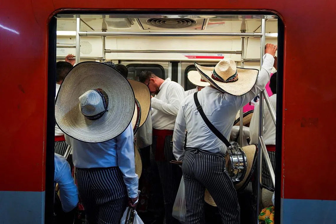 Military personnel wearing traditional costumes traveling in the metro to Zocalo Square, to participate in a parade to mark the 114th anniversary of the Mexican Revolution, in Mexico City, Mexico Nov 20, 2024. 
