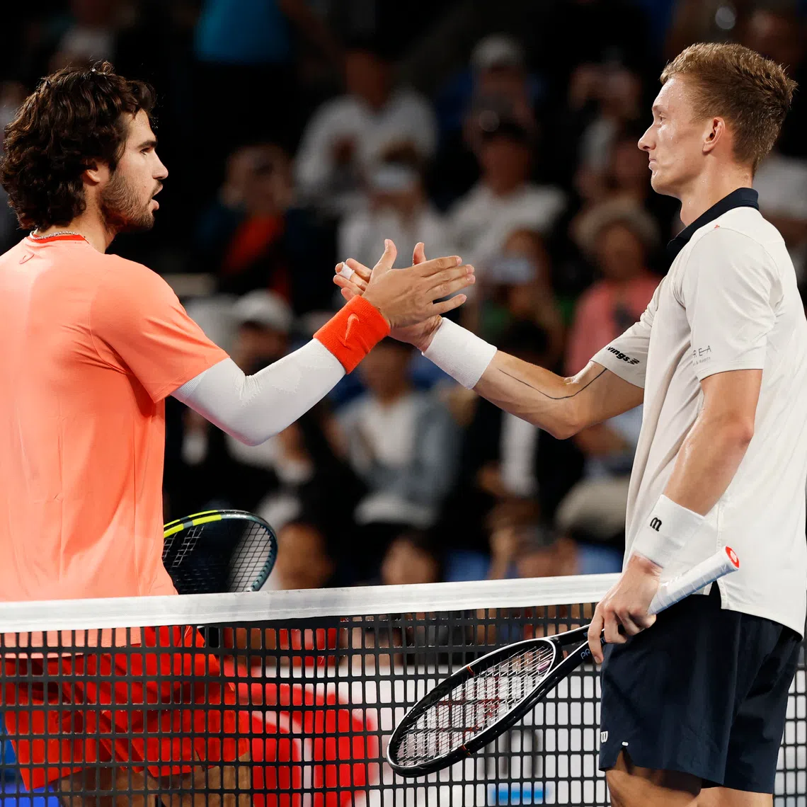 Spain’s Carlos Alcaraz (left) shakes hands with Czech Republic’s Jiri Lehecka after retaining his title.