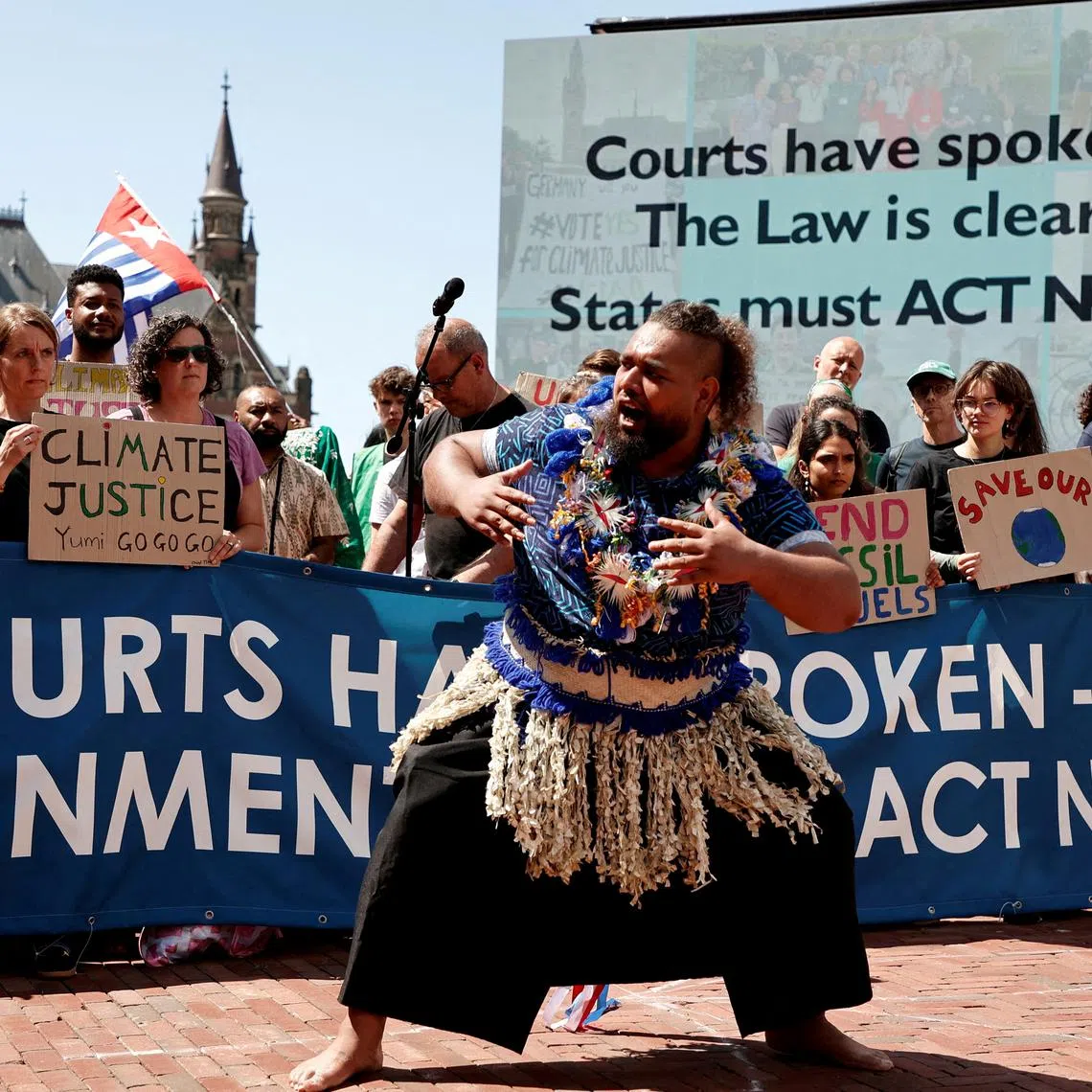 FILE PHOTO: Climate activists and campaigners demonstrate outside the International Court of Justice (ICJ) ahead of the reading of an advisory opinion that is likely to determine the course of future climate action across the world, The Hague, Netherlands, July 23, 2025. REUTERS/Marta Fiorin/File Photo