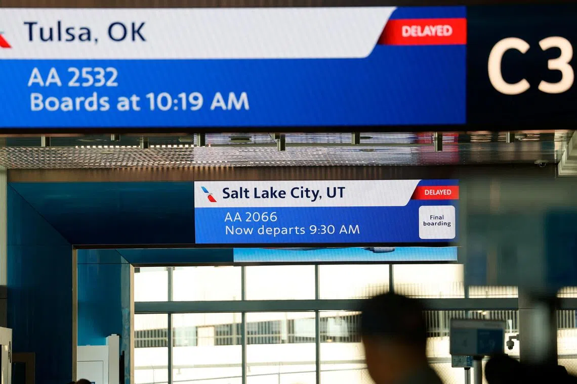 Screens display flight information at the Terminal C in Dallas Fort Worth Airport, in Dallas, Texas.