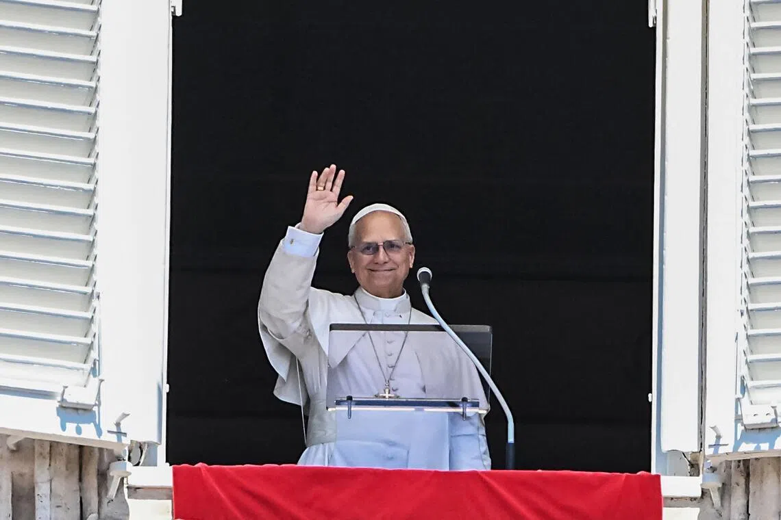 Pope Leo XIV waves from the window of the apostolic palace overlooking St Peter's square during the Regina Coeli prayer in The Vatican on April 26, 2025.