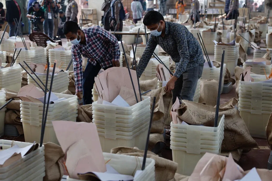 Officials giving a final check before dispatching the ballot boxes to voting centres, a day ahead of Bangladesh's general election, in Dhaka on Feb 11.