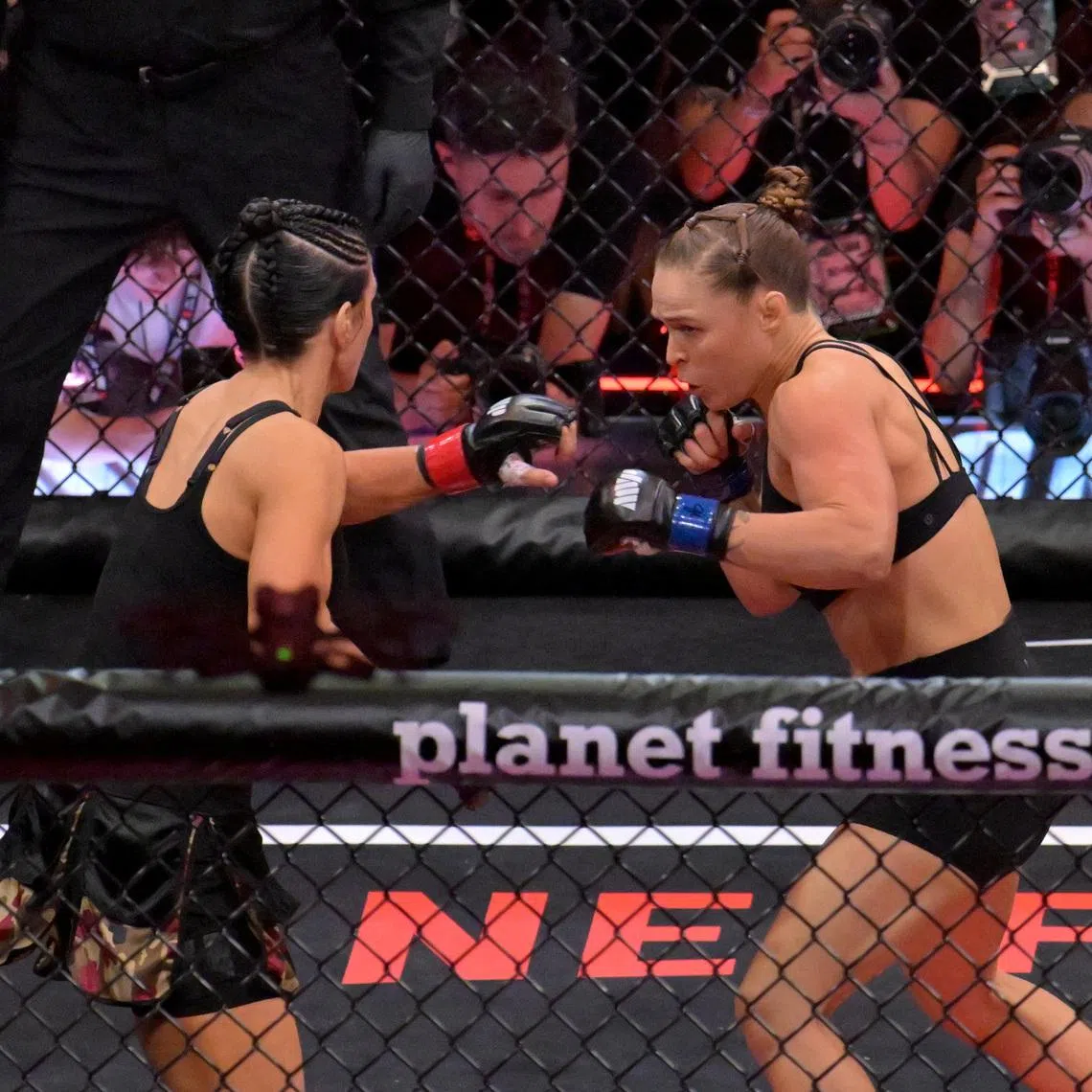 May 16, 2026; Los Angeles, California, USA;  Ronda Rousey (blue gloves) fights Gina Carano (red gloves) in a women's featherweight bout at Intuit Dome. Mandatory Credit: Jayne Kamin-Oncea-Imagn Images