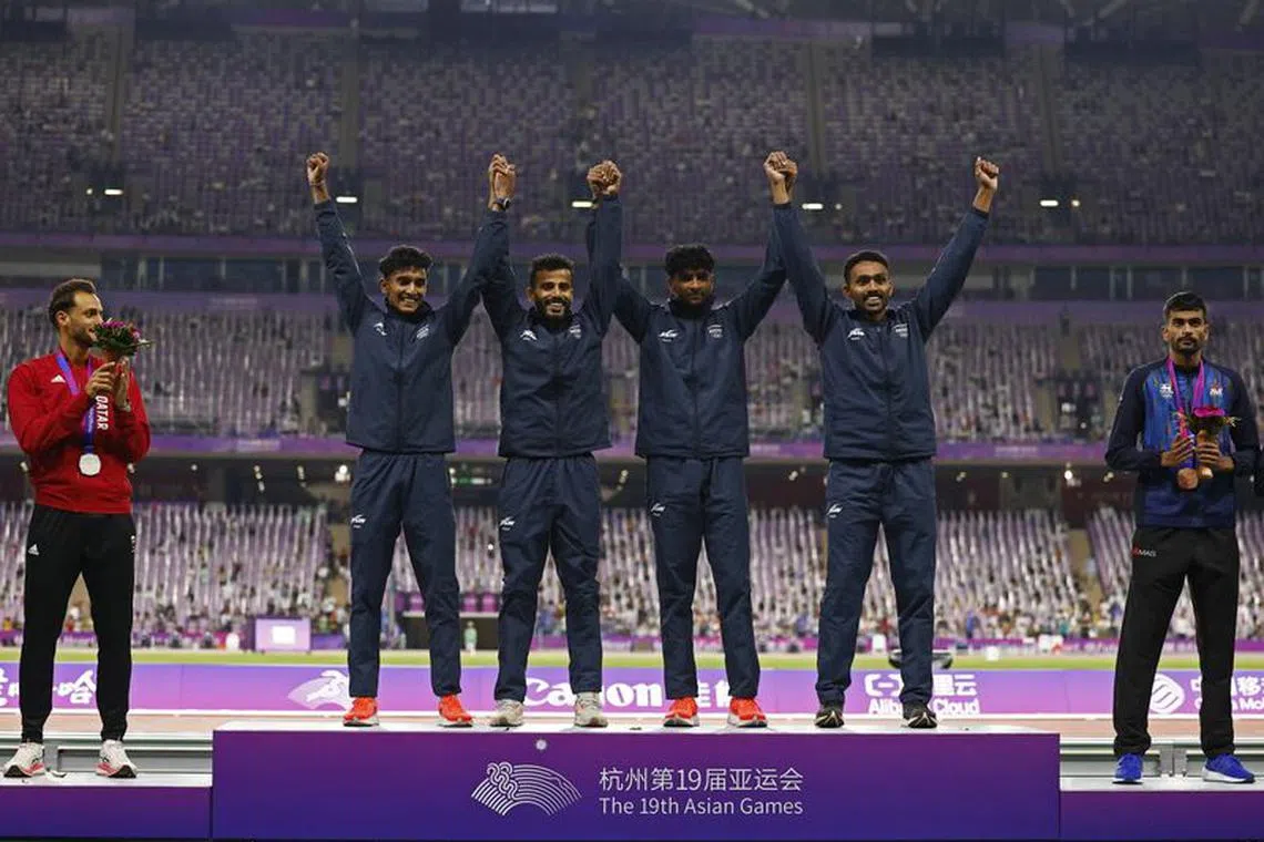 FILE PHOTO:Asian Games - Hangzhou 2022 - Athletics - Olympic Sports Centre, Hangzhou, China - October 4, 2023 Gold medallists from team India react during the medal ceremony for the Men's 4 x 400m Relay Final REUTERS/Tingshu Wang/File Photo