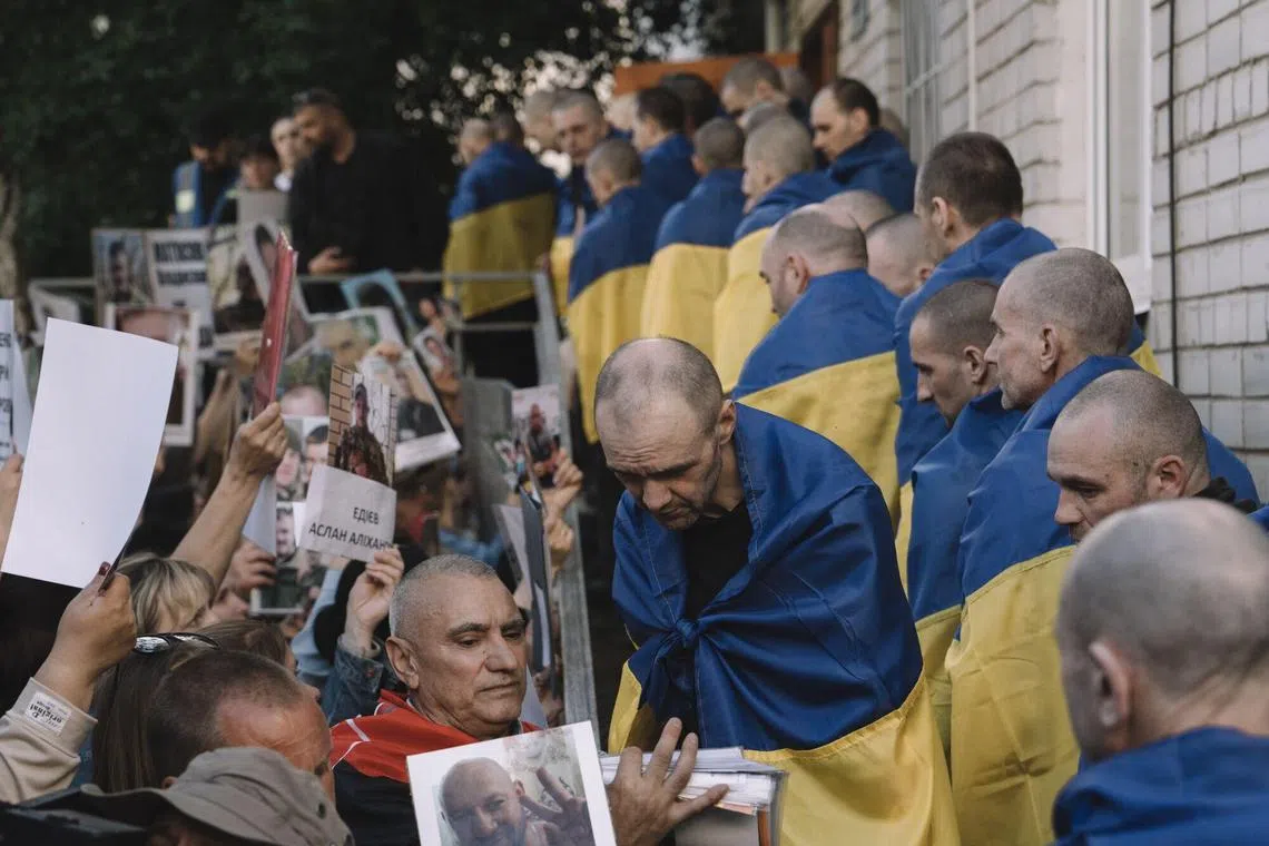 ‘Seventh heaven’: Tears and laughter as Ukrainian POWs return